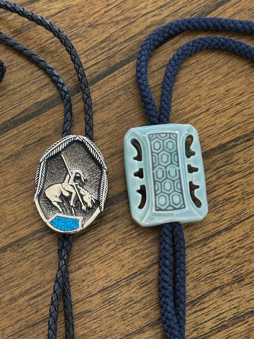 Two Bolo Ties 1) Silver Slide w/Leather Cord 2) Green Ceramic Slide w/Navy Cord